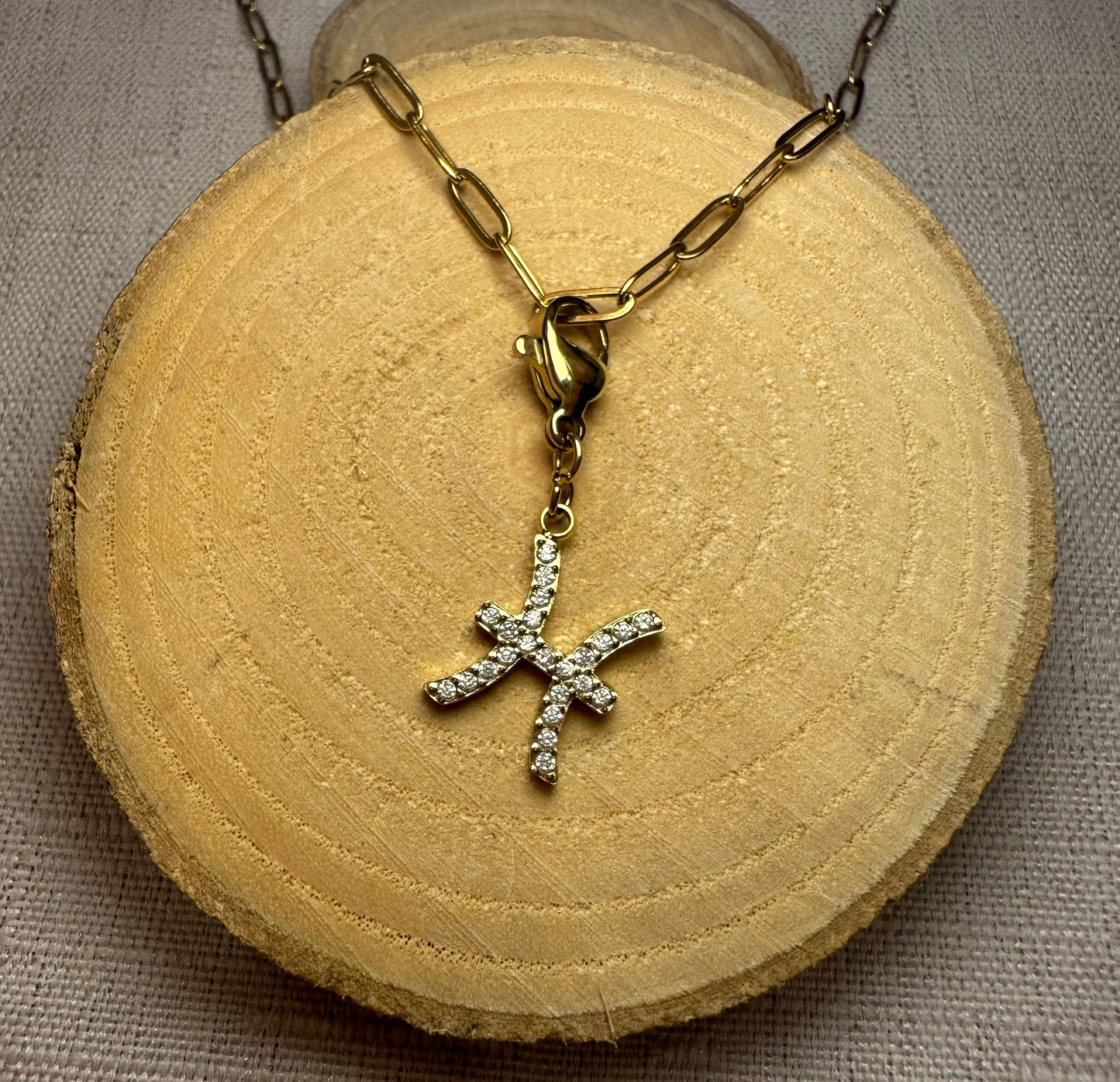 Signe astro doré strass Alaïa Bijoux
