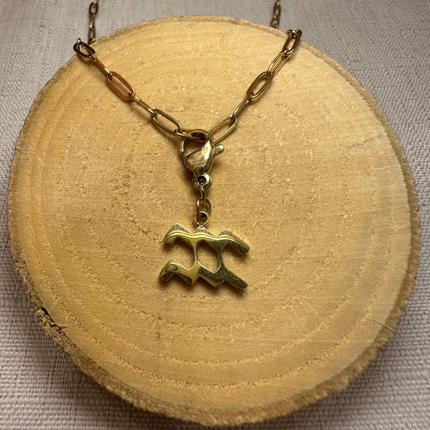Signe astro doré Alaïa Bijoux