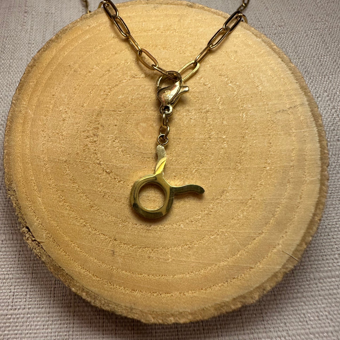 Signe astro doré Alaïa Bijoux